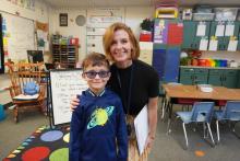 A student with his teacher on the first day of school