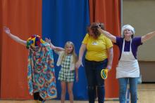 First grade student celebrating her hard work with the Story Bakers