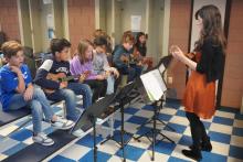 Third grade students performing their strings concert during lunch