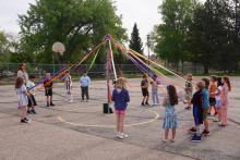 Second grade students performing the annual May Pole dance