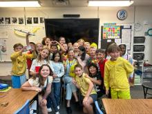 Students celebrating their teacher in a group photo