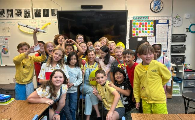 Students celebrating their teacher in a group photo