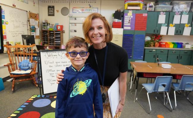 A student with his teacher on the first day of school