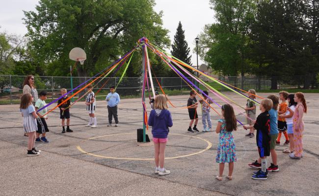 Second grade students performing the annual May Pole dance