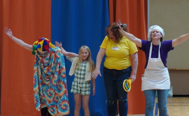 First grade student celebrating her hard work with the Story Bakers